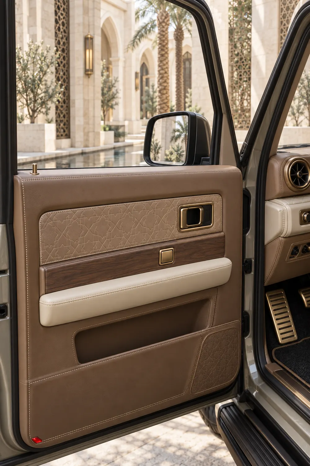 A mocha leather QAF door card with subtle geometric embossing and a brass pull