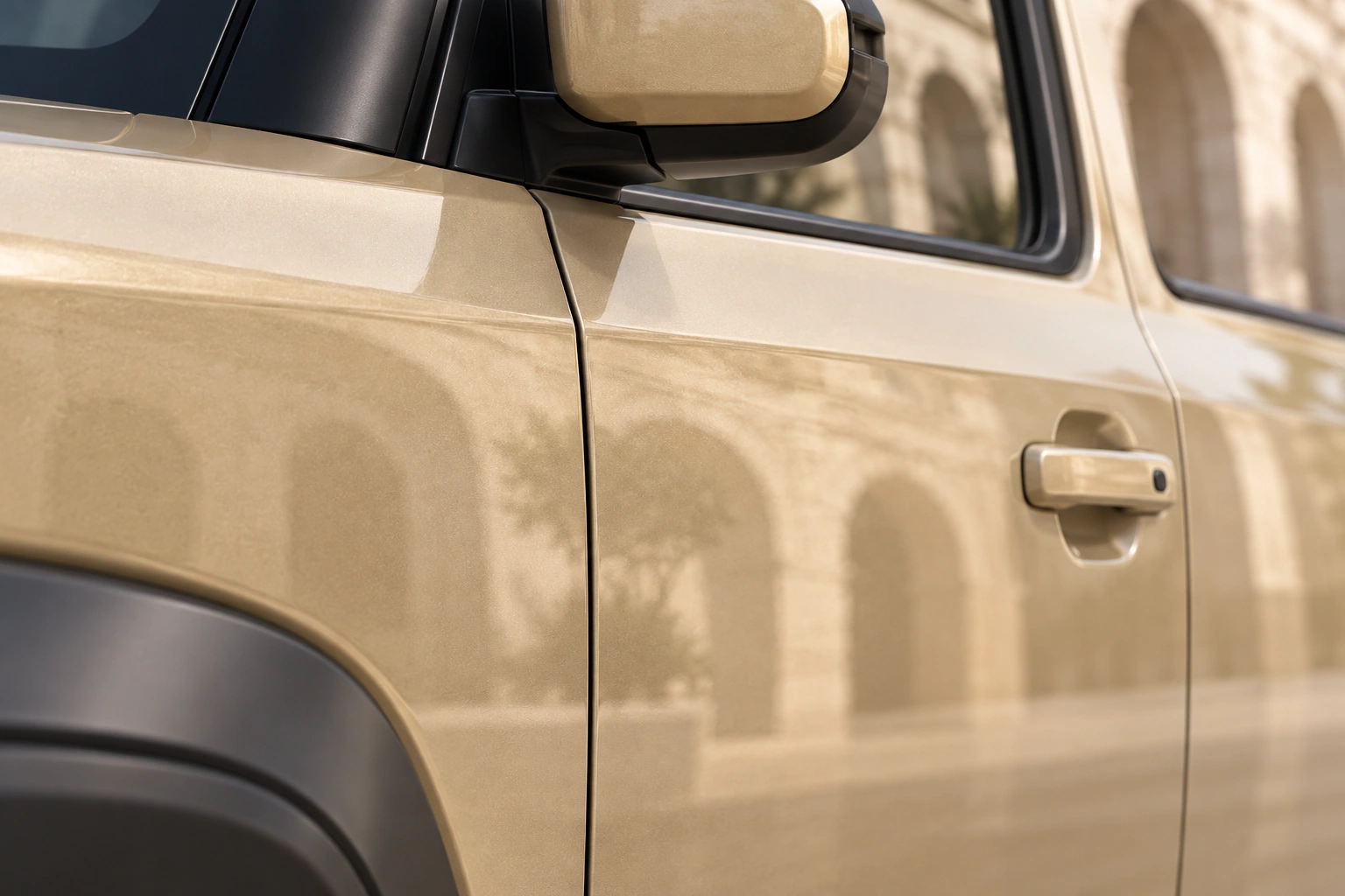 Fine sand-gold paint, a door handle and a precise panel gap in natural light